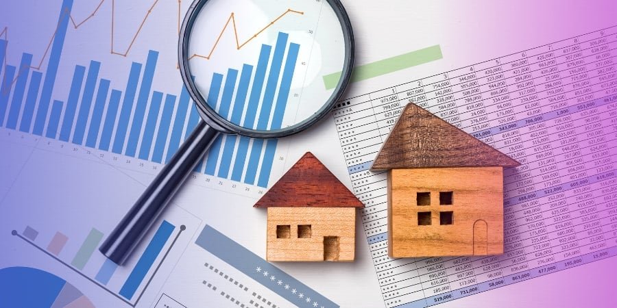 A magnifying glass hovers over financial graphs and charts, highlighting the nuances of real estate data. Two wooden house models, one larger and one smaller, suggest strategies on how to generate real estate leads while analyzing the housing market trends.
