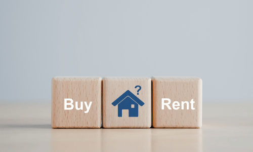 Three wooden blocks read "Buy," a house icon with a question mark, and "Rent," symbolizing the decision between homeownership options.