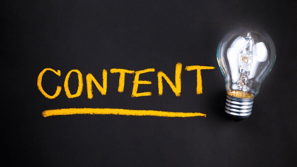 A glowing light bulb beside the word "CONTENT" written in bright yellow chalk on a dark background.