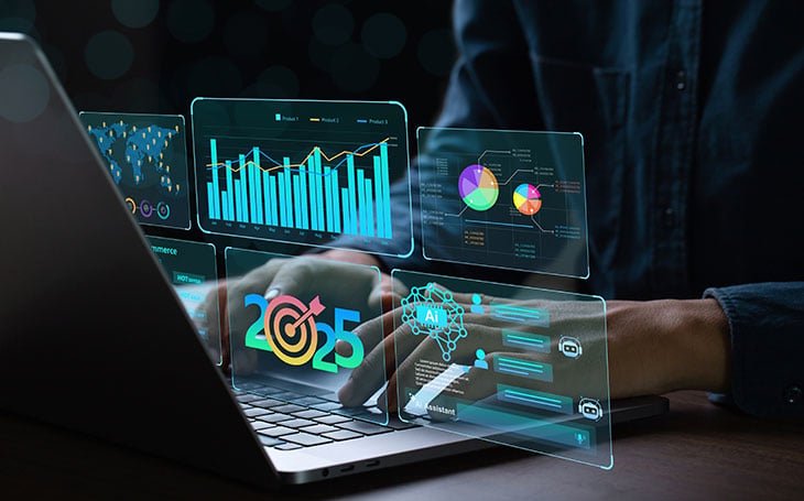 Person typing on a laptop with virtual graphical interfaces displaying charts, AI icons, and data analytics—illustrating advanced technology use for the Top 10 Real Estate Marketing Tools for 2025.
